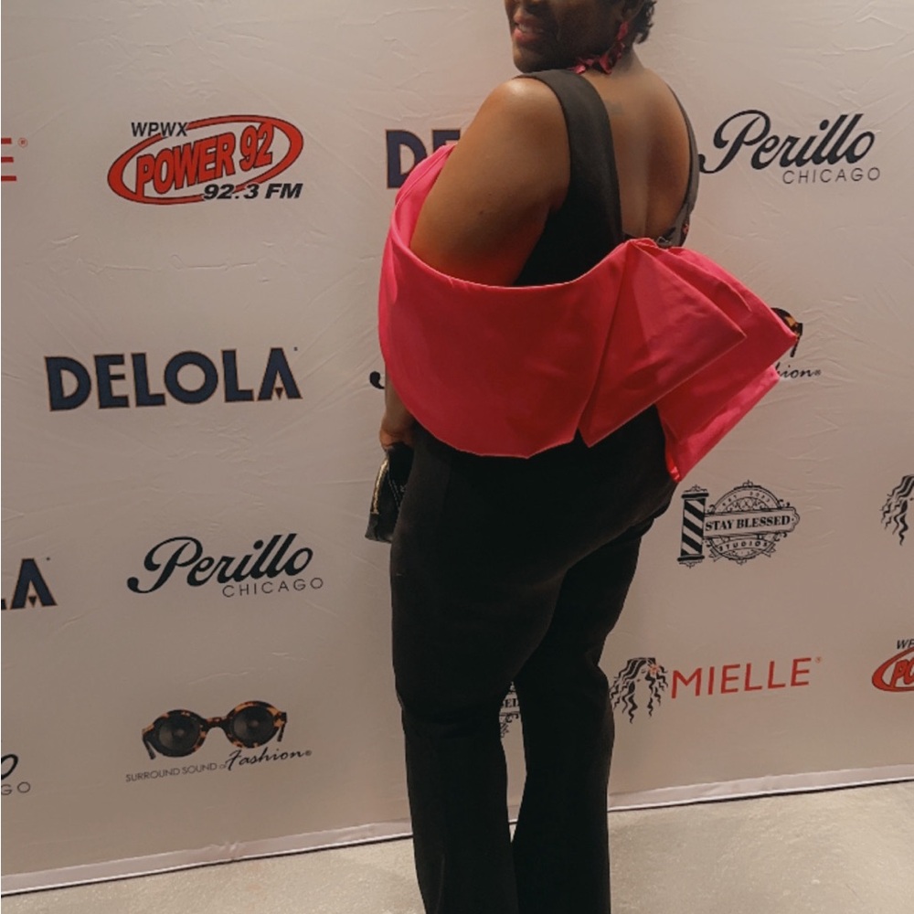 Beautiful jumpsuit with a big pink bowl attached to the back very stretchy